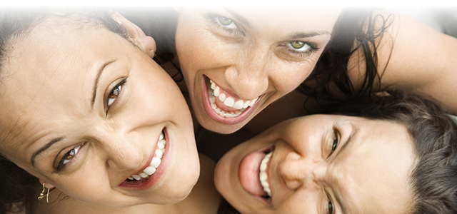 Image of three females laughing.